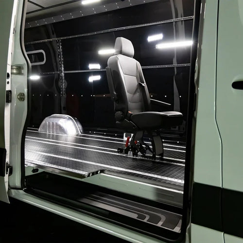 Modular aluminum SmartFloor track system installed in a Ford Transit for safety-tested seating and modular gear storage.