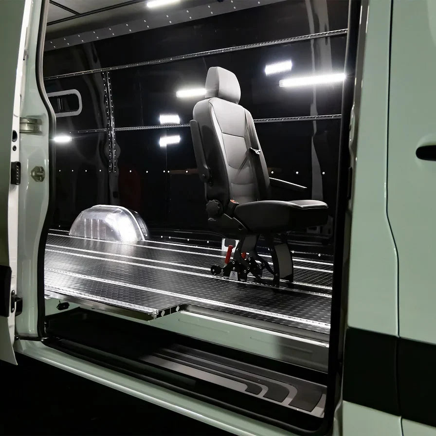 Modular aluminum SmartFloor track system installed in a Mercedes-Benz Sprinter for FMVSS-compliant seating and furniture.