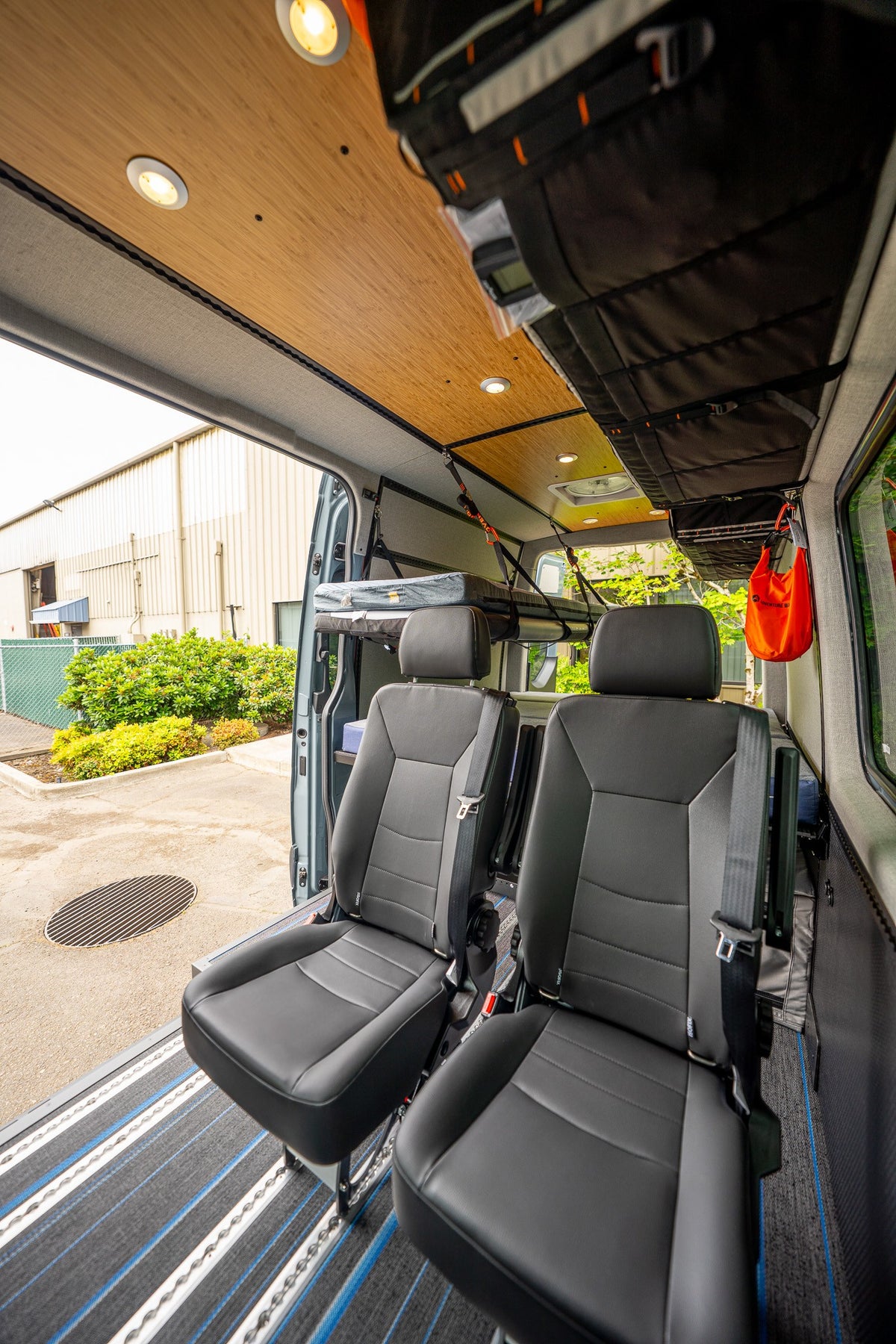 Two removable passenger seats mounted on Smartfloor rails inside a finished van