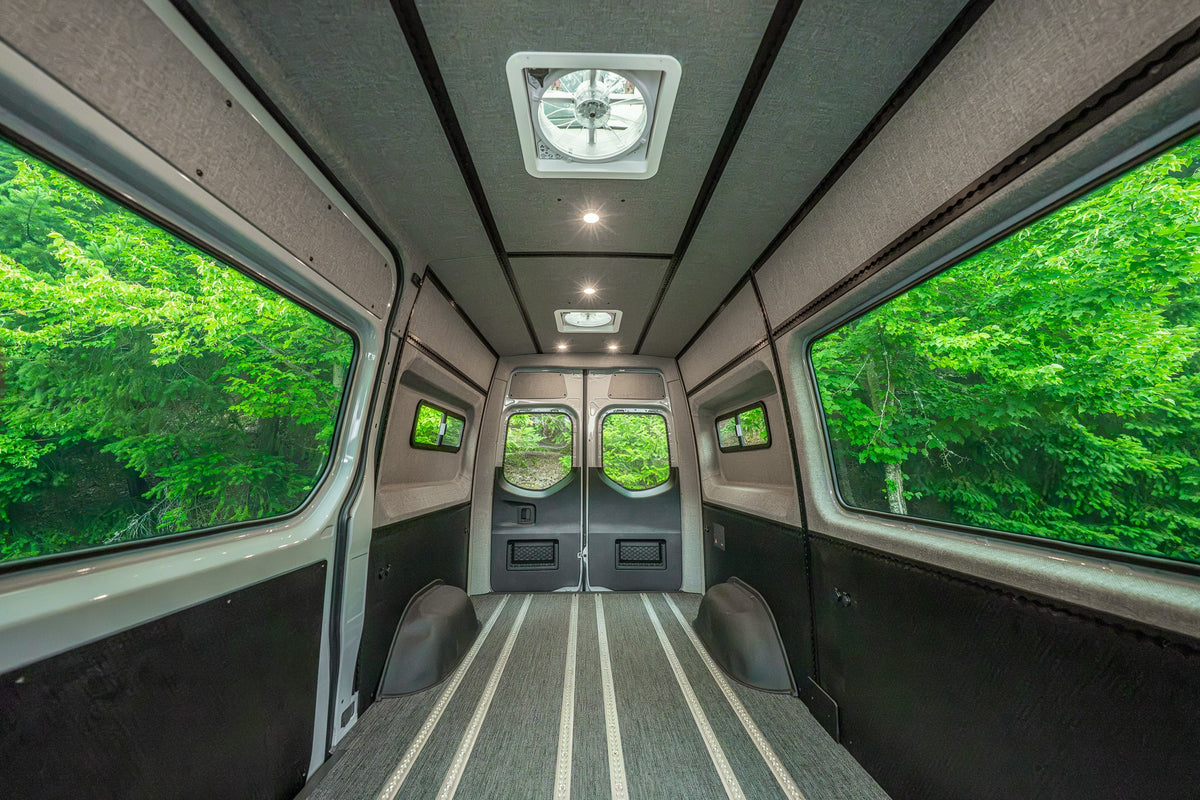 Wide interior view of an empty cargo van fitted with Smartfloor rails