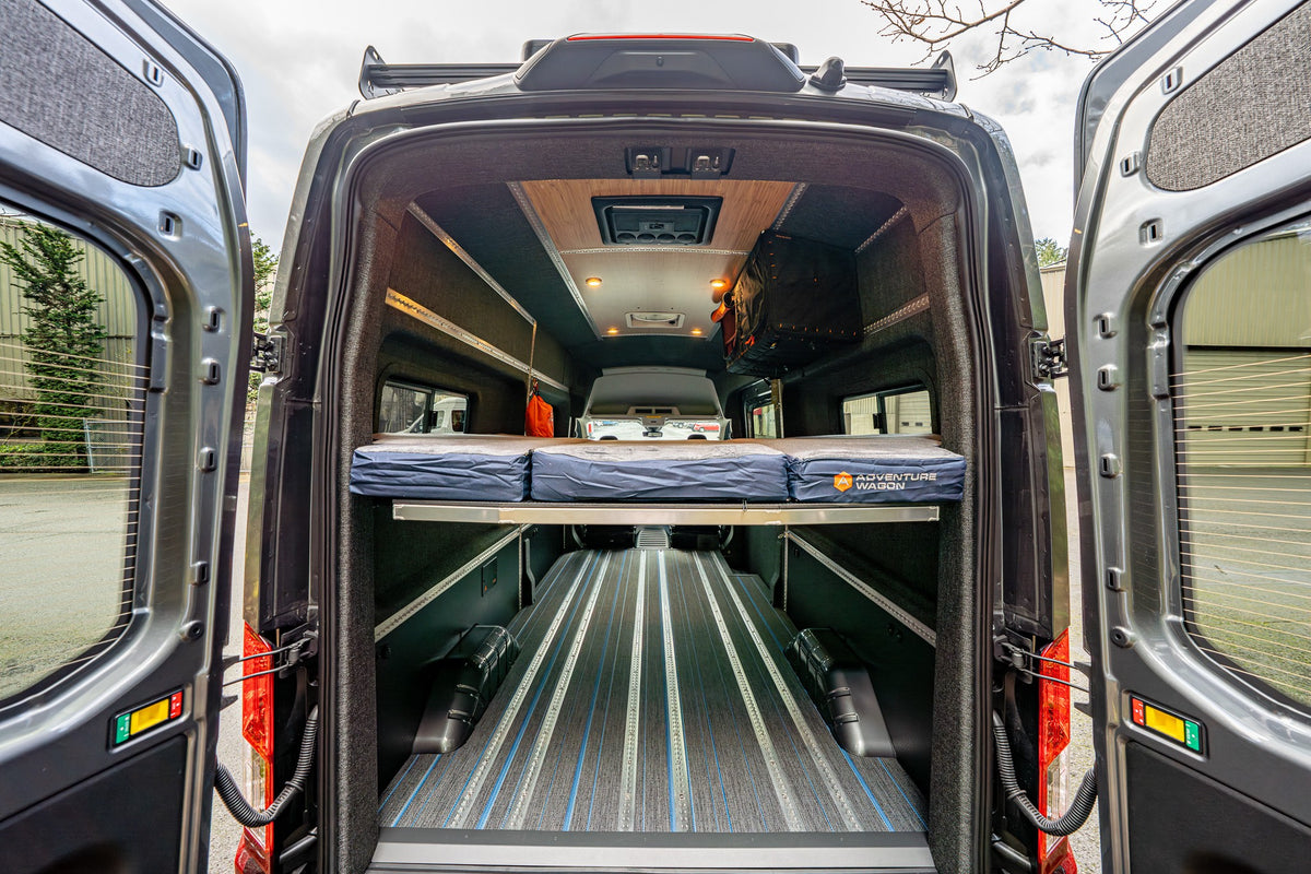 Rear door view of a Smartfloor-equipped van with an elevated bed platform