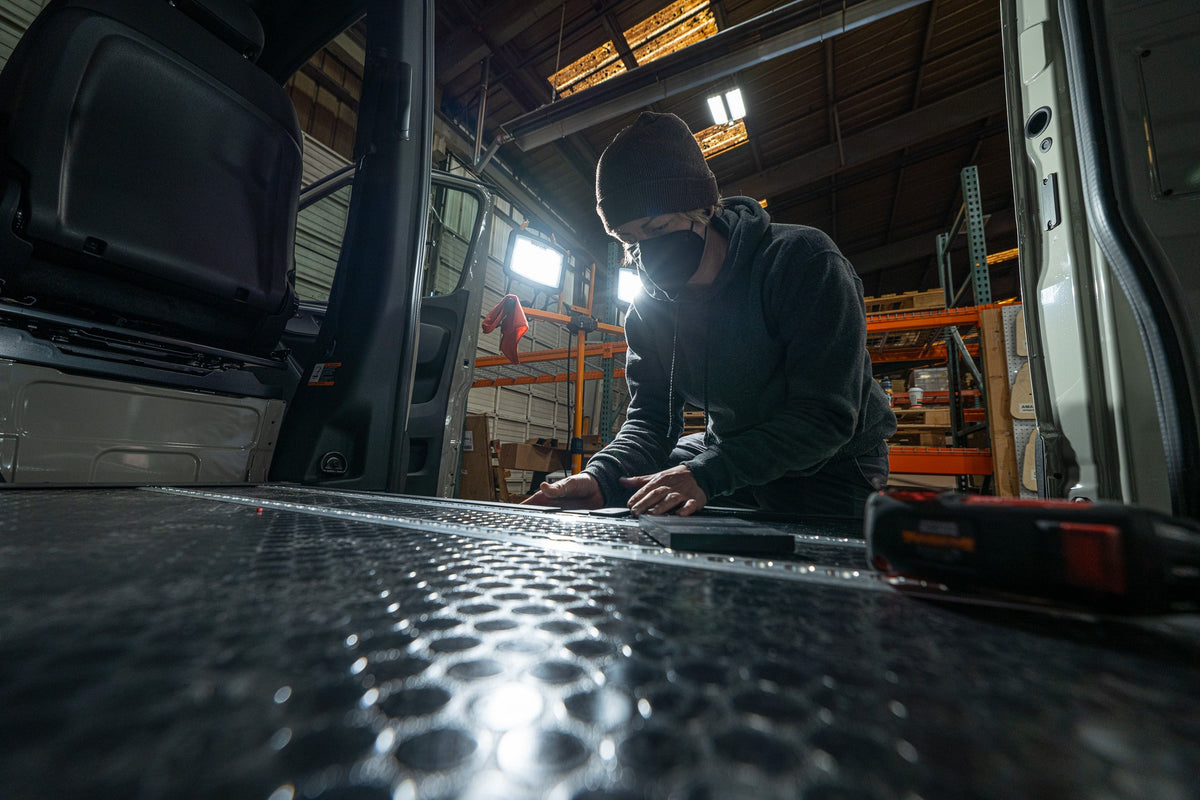 Installer fitting a floor panel inside a van during a Smartfloor installation