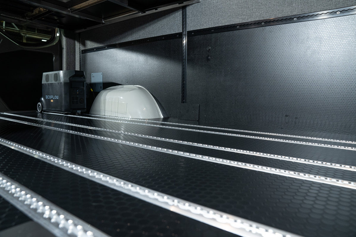 Clean black van floor with parallel aluminum Smartfloor rails