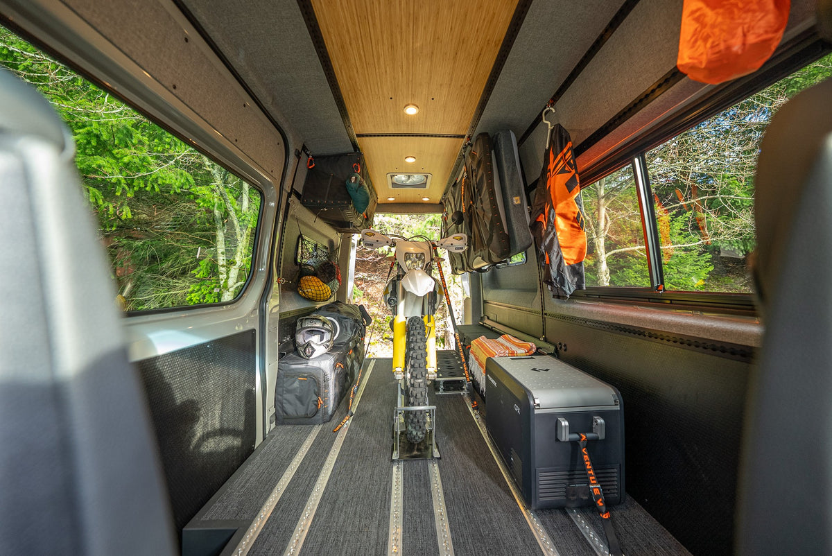 Motorcycle and travel equipment organized inside a van with Smartfloor rails